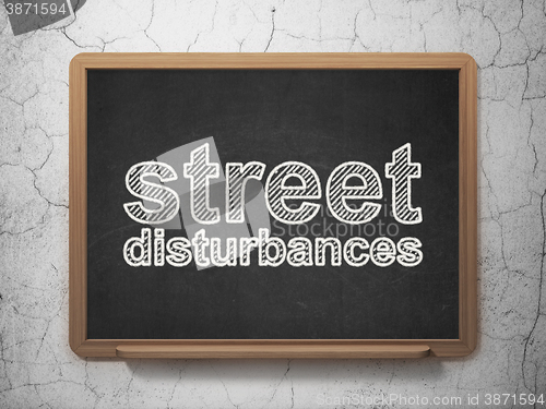 Image of Political concept: Street Disturbances on chalkboard background