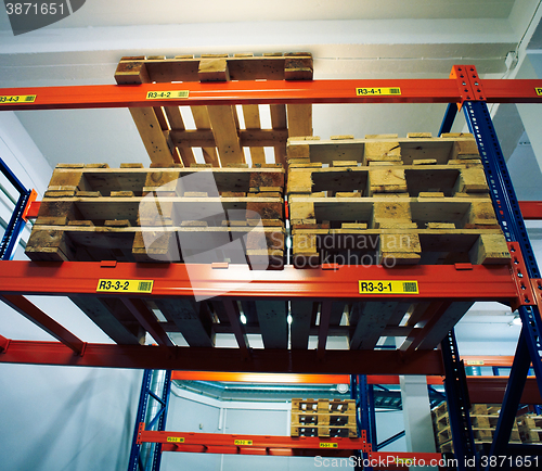 Image of Shelves and racks with pallets in distribution warehouse interio