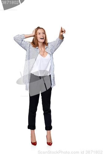 Image of Happy excited woman in full length pointing to the side