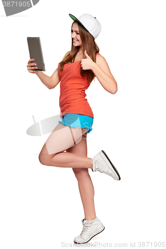 Image of Full length sporty female with digital tablet