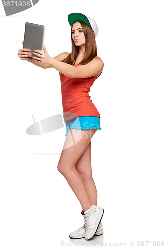 Image of Full length sporty female with digital tablet