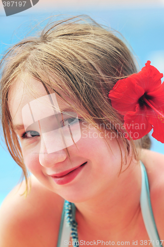 Image of Portrait of a girl with red flower