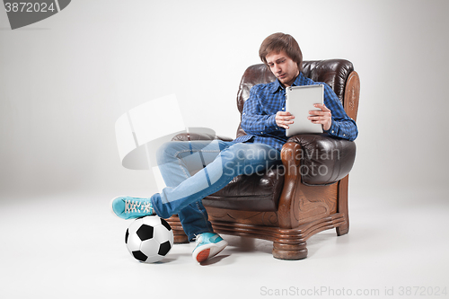 Image of Portrait of young man with laptop and football ball