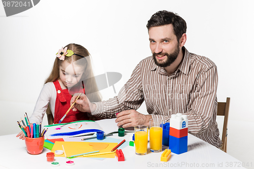 Image of The daughter and father drawing together
