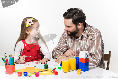 Image of The daughter and father drawing together