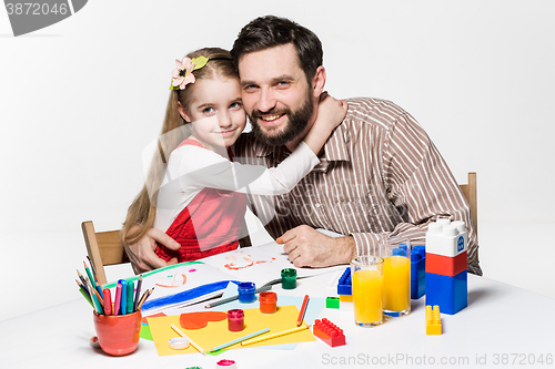 Image of The daughter and father drawing together