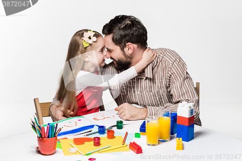 Image of The daughter and father drawing together
