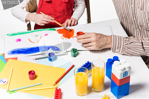 Image of The daughter and father drawing together