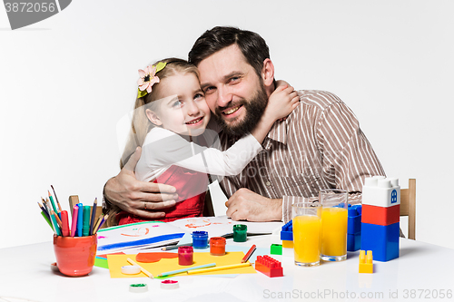 Image of The daughter and father drawing together