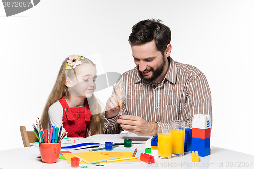 Image of The daughter and father drawing together