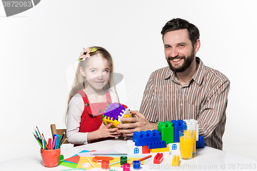 Image of Father and daughter playing educational games together 