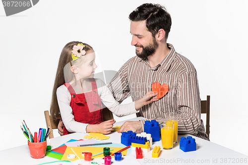 Image of Father and daughter playing educational games together 