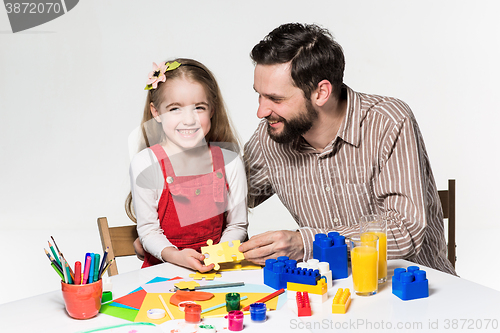 Image of Father and daughter playing educational games together 