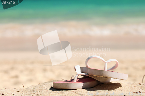 Image of Flipflops on a sandy beach