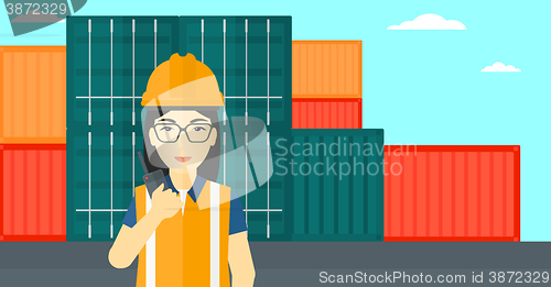 Image of Stevedore standing on cargo containers background.