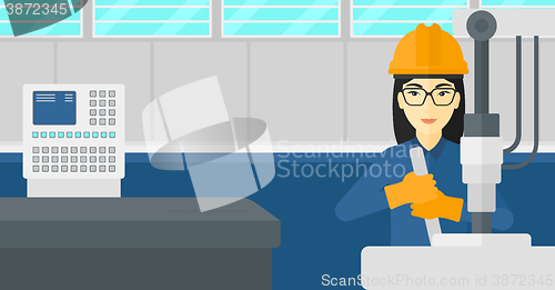 Image of Woman working with industrial equipment.
