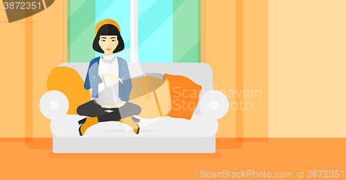 Image of Pregnant woman sitting on sofa.