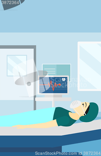 Image of Patient lying in hospital bed with heart monitor.