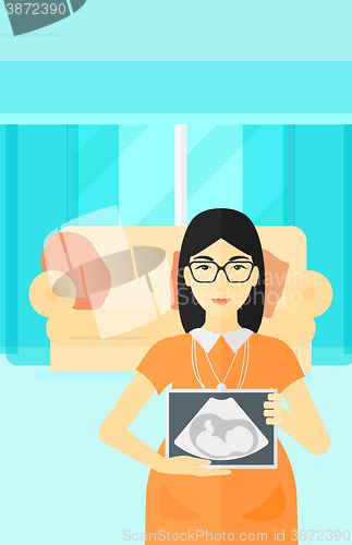 Image of Pregnant woman with ultrasound image.