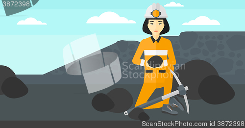 Image of Miner holding coal in hands.