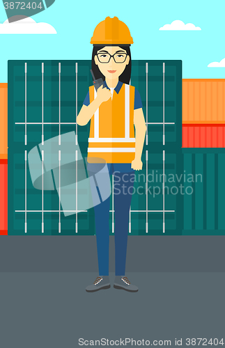 Image of Stevedore standing on cargo containers background.