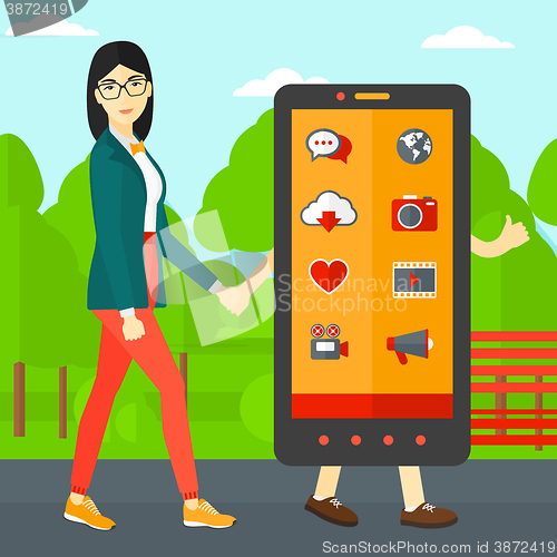 Image of Woman walking with smartphone.