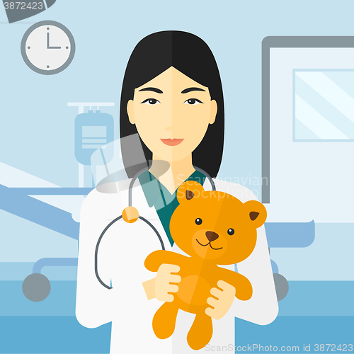 Image of Pediatrician holding teddy bear.