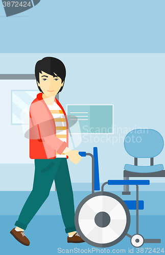 Image of Man pushing wheelchair.