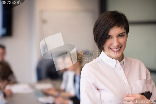 Image of hispanic businesswoman with tablet at meeting room