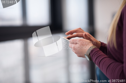 Image of business woman using smart phone at office