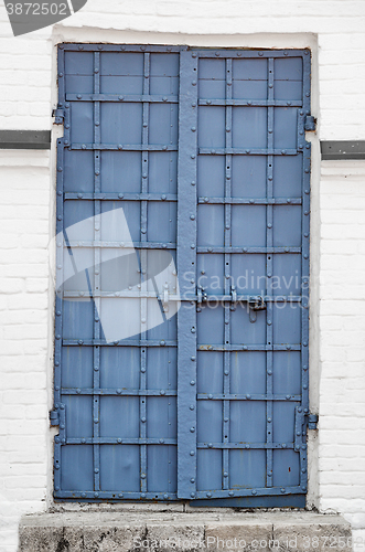 Image of Reinforced Iron Door with Rivets and Security Bolt