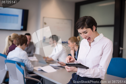 Image of business woman on meeting  using tablet