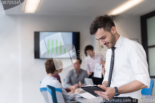 Image of young business man with tablet at office meeting room