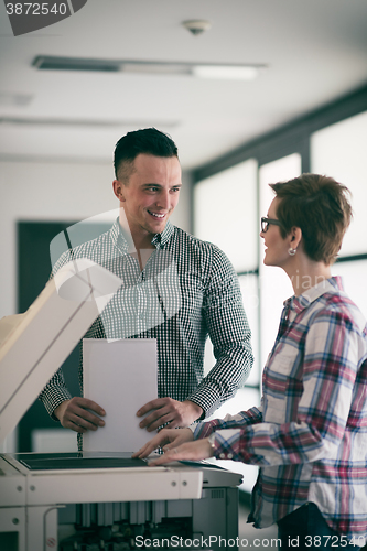 Image of business couple copy documents