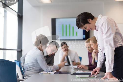 Image of young  woman using  tablet on business meeting