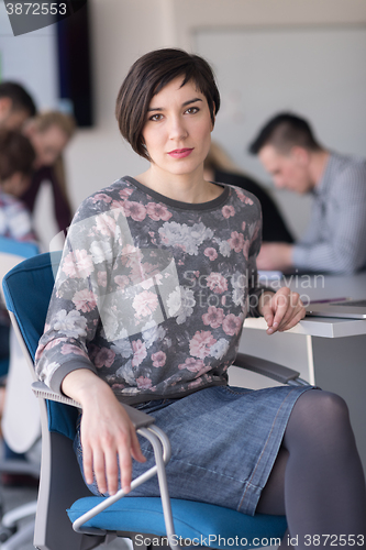 Image of portrait of young business woman at office with team on meeting 