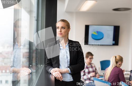 Image of portrait of young business woman at office with team on meeting 