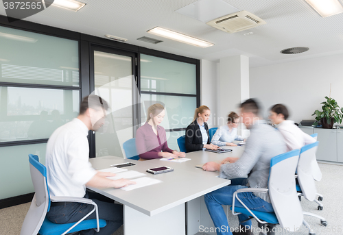 Image of business people group entering meeting room, motion blur