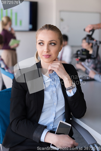 Image of portrait of young business woman at office with team on meeting 
