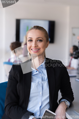 Image of portrait of young business woman at office with team on meeting 