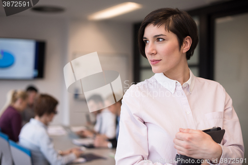 Image of hispanic businesswoman with tablet at meeting room