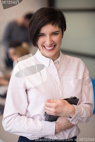 Image of hispanic businesswoman with tablet at meeting room