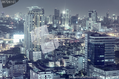 Image of Downtown night scene, beautiful modern buildings, bright glowing