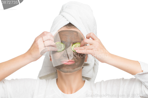 Image of Young beautiful woman in mask for the face. therapeutic black clay. Spa treatment.
