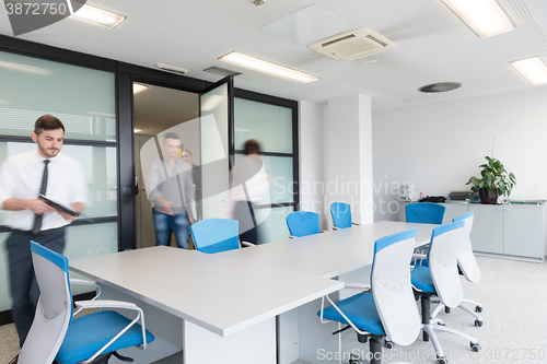 Image of business people group entering meeting room, motion blur