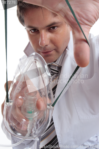 Image of Doctor applying mask to patient