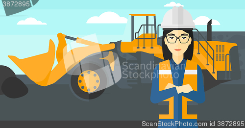 Image of Miner with mining equipment on background.