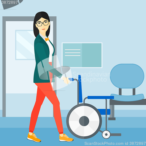 Image of Woman pushing wheelchair.
