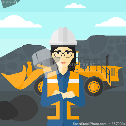 Image of Miner with mining equipment on background.