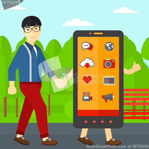 Image of Man walking with smartphone.